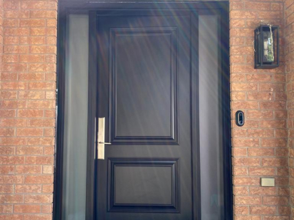 black door with bricks